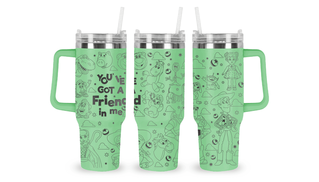 Engraved tumbler featuring Toy Story characters like Woody, Buzz Lightyear, and aliens with playful, starry accents