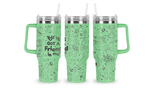 Engraved tumbler featuring Toy Story characters like Woody, Buzz Lightyear, and aliens with playful, starry accents